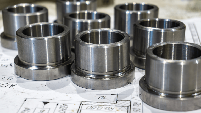 group of metal bushings on top of a technical drawing